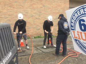 two studens use power drills