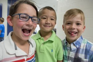 Three kindergarten boys ham it up for the camera