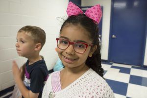 A girl with a pink bow in her hair