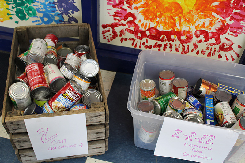 Two bins filled with cans of food, part of the celebration of the number two