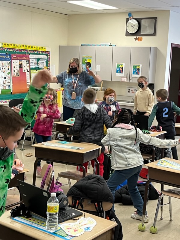 A classroom with smaller elementary children all up and dancing.