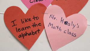 A red heart on left and pink one on right. They say I love to learn the alphabet and Mr. Healy's math class