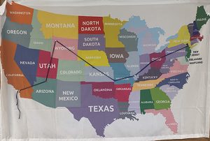 A map of the United States with all of the states named. There is a line marking a route from New York, through Ohio, down to Kansas, up to Wyoming, down nto Arizona and across to southern California.. Each state is a different color.