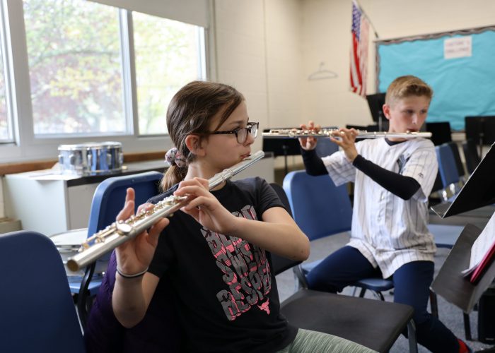 Two students play flutes