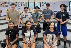 Students holding instruments pose for a photo