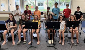 Students holding instruments pose for a photo