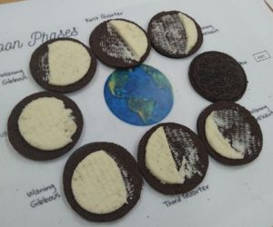The phases of the moon displayed as Oreos with the filling  removed