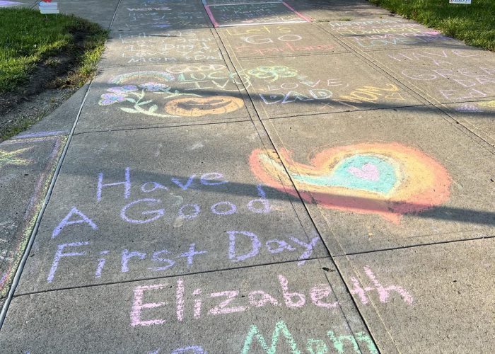 Messages written in chalk are seen on the sidelwalk