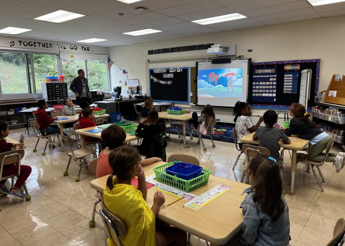 Teacher speaking to classroom of students