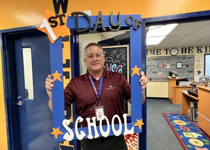 A person holds a first day of school frame