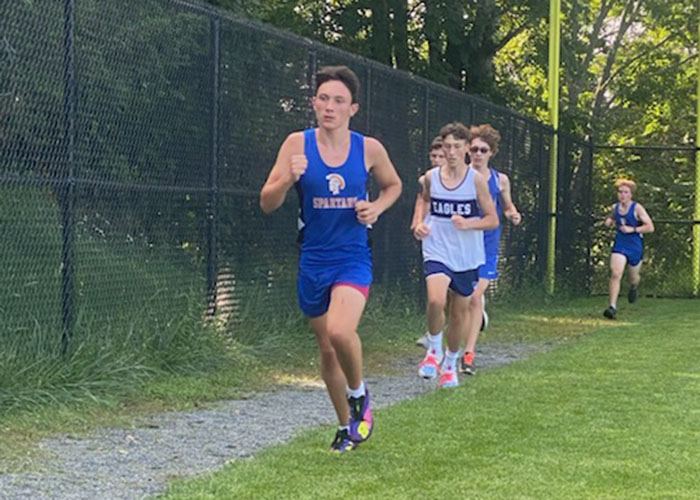 Students run during a cross country meet.