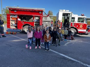 Student in front of fire truck