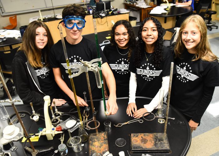 Students wearing black pose for a photo