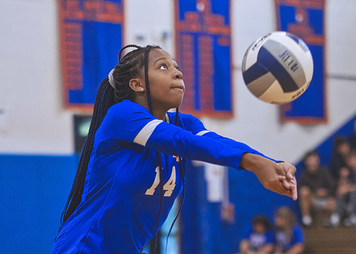 A volleyball player bumps the ball during a game