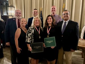 Group photo of board of ed members, and award winners presenting their certificates