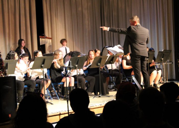 Students and teacher during band performance