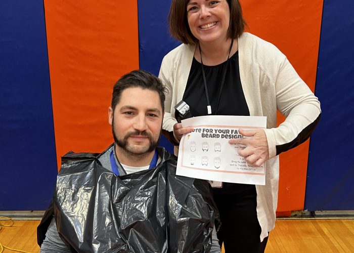 Teacher and principal pose for No Shave November Event