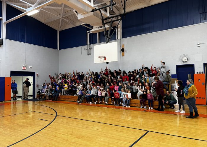 Students in cheering in bleachers