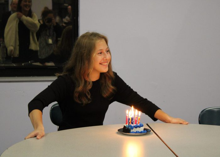 Student in front of cake with candels