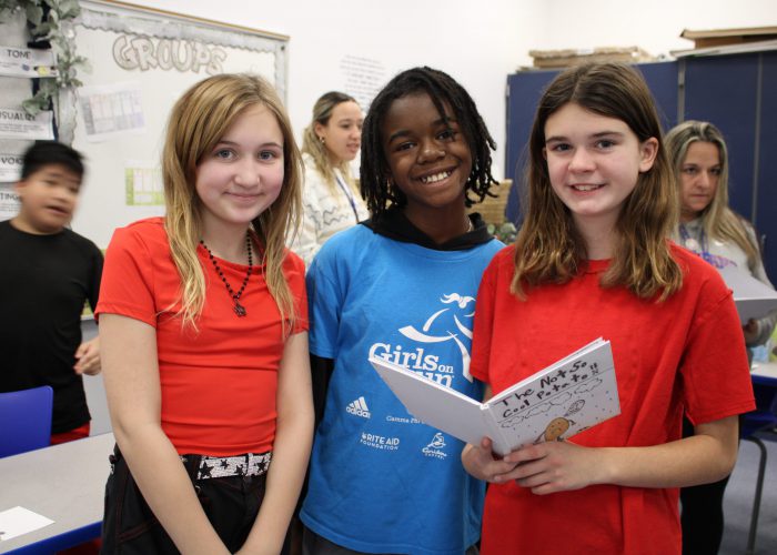 three students smiling