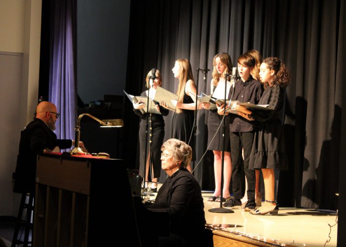 Students singing on stage