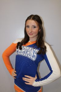 Cheerleader posing for photo in blue and orange uniform
