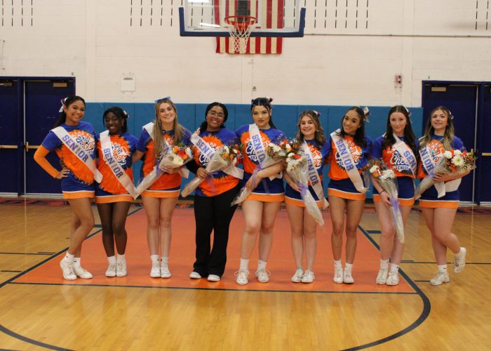 Cheerleaders pose in uniforms