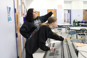Students work on light and sound board during rehearsal for the play