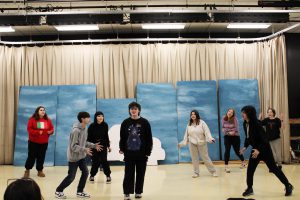 Students rehearse scene on stage