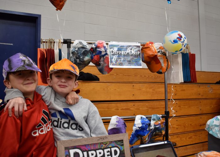 Vincent Patanio and Joseph Riordan sell hats at TREP$