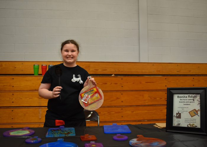 Ryleigh Bonita sells cutting boards and spoon rests at TREP$ market