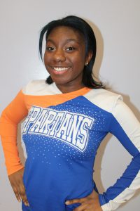 Cheerleader Alicia Ward smiles for the camera in her uniform