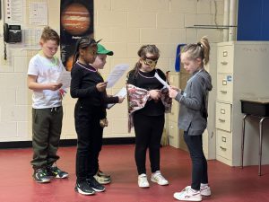 a team of five primary students put on a performance