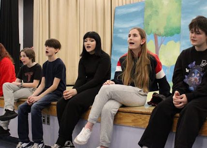 Students sing at rehearsal for play
