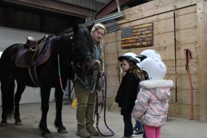 Students learn from instructor at Winslow field trip