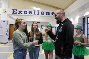 student and principal Michael Maesano play rock paper scissors during St. Patrick's rock paper scissors tournament