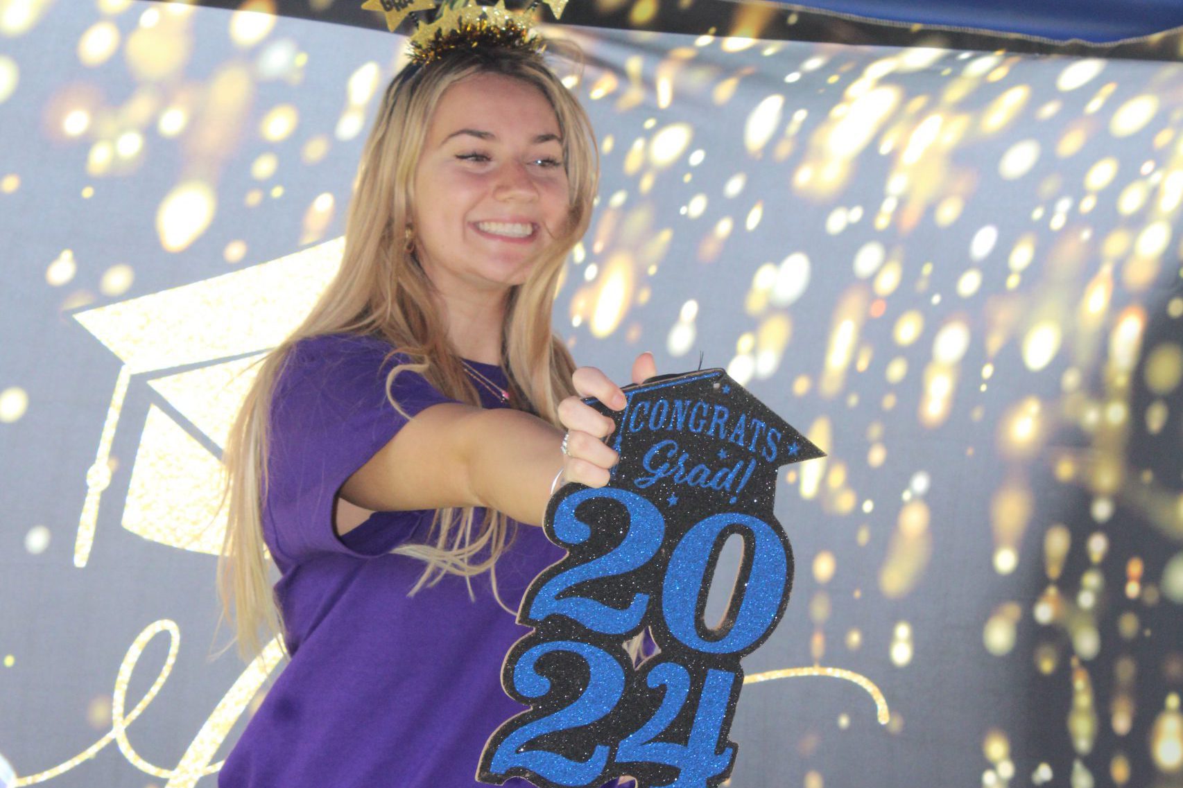 Student poses for photo in photo booth