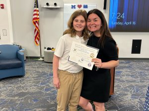 Jameson Sauka and his teacher Kate Riehle pose with Sauka's award