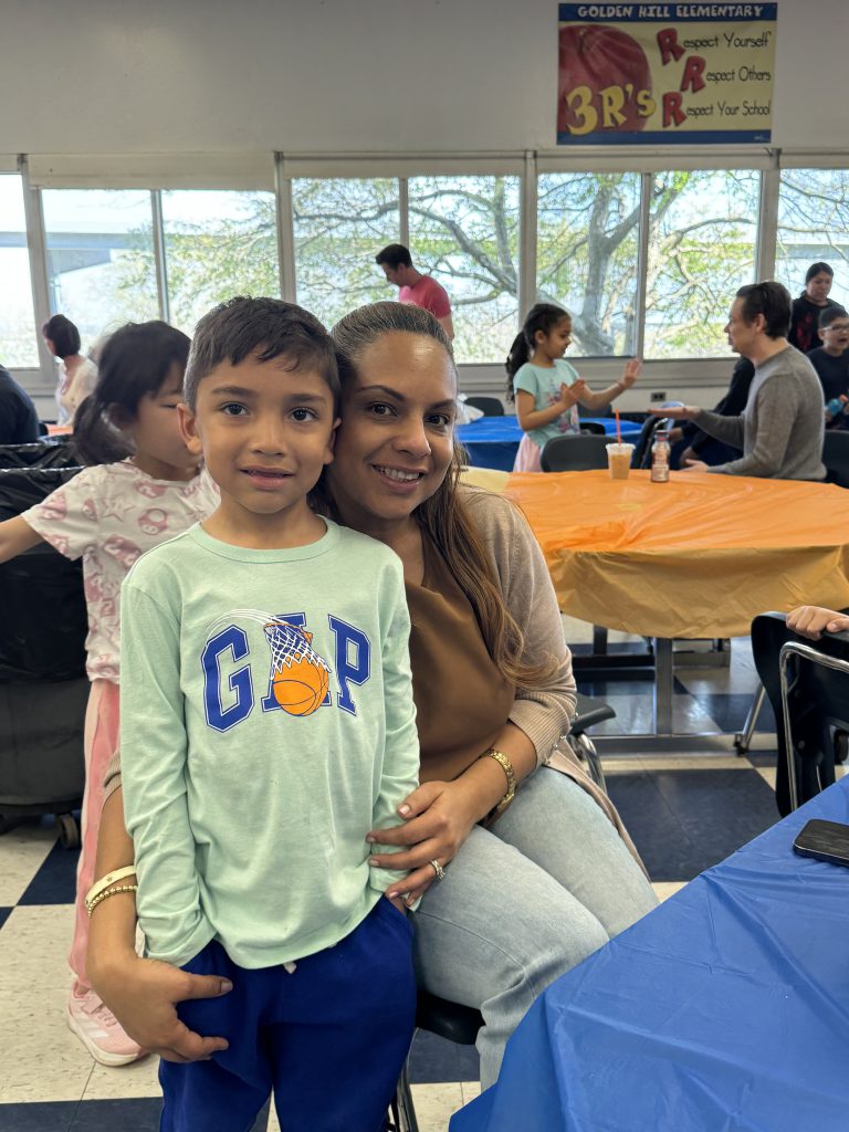 Student poses with his mom