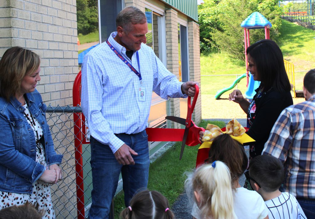 Superintendent and BOE member cut ribbon at new playground