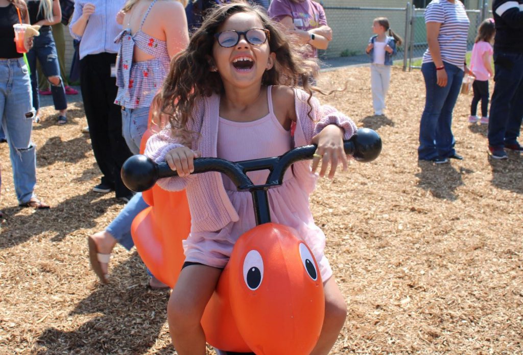 Studnet playing on bug at new playground